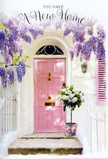 This photograph evokes the gentle anticipation of a new chapter in Belmont, as if someone has paused on the front step to take in their new surroundings. The doorway itself is painted a tender, powder-pink, its smooth surface softly illuminated by natural daylight, inviting you inward with a sense of comfort and charm. Above and around it, wisteria flows in profuse lavender strands, each flower cluster tumbling down in loose, romantic waves against the clean white wall. The overall effect feels like a pastel vignette you might stumble upon while wandering the quiet streets near Belmont's leafy residential pockets: intimate, welcoming, and distinctly personal.

At the threshold, a generous floral display completes the story. Plush white and cream roses, fully bloomed and velvety, are arranged in a tasteful, slightly rustic grey bucket. The metal container bears a gentle, brushed look that contrasts beautifully with the softness of the petals. Sprigs of lush green foliage peek between the blossoms, adding freshness and volume, while a soft pink ribbon is tied around the bucket's base in a relaxed yet deliberate bow. The colours echo the door and the overhead wisteria, creating a cohesive, soothing palette of pinks, whites, greens, and purples. You can almost imagine the calm of a Belmont afternoon, birdsong in the distance, and the faint fragrance of flowers drifting on the air. It feels like a quiet, heartfelt gesture-a floral welcome perfect for celebrating a move, blessing a new space, or marking a milestone where home, hope, and the promise of future memories come together at the doorstep.
